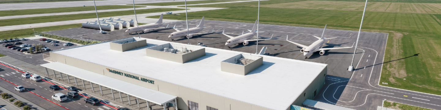 This is an aerial view of a rendering of the new Commercial Service Airport. It shows the terminal building parking, and taxiways.